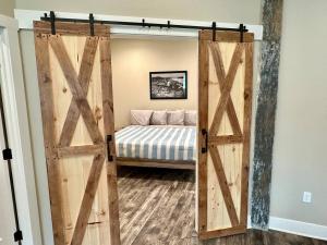 a sliding barn door in a bedroom with a bed at River Stone Villa - 2Bedroom/2Bath - No Step Entry in Bellevue