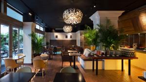 a restaurant with tables and chairs and a bar at Holiday Inn Osaka Namba by IHG in Osaka