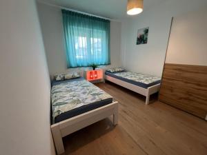 a room with two beds and a window at Apartment CReO Loborika in Marčana