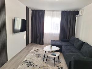 a living room with a couch and a table at Nova Residence Craiova in Craiova
