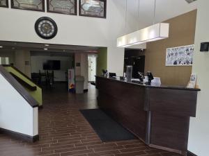 a lobby with a bar with a clock on the wall at Austinburg Hotel in Austinburg +22 photos