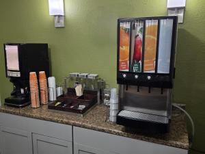 a counter with a coffee maker and a coffee machine at Austinburg Hotel in Austinburg