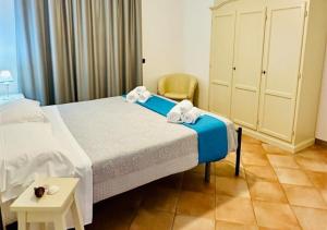 a bedroom with a bed with towels on it at Near Acquamorta Beach - Villa Lamberti Casa Sole in Monte di Procida