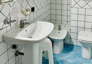 a white bathroom with a sink and a toilet at Near Acquamorta Beach - Villa Lamberti Casa Sole in Monte di Procida +24 photos