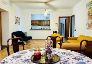 a living room with a table with a vase on it at Near Acquamorta Beach - Villa Lamberti Casa Sole in Monte di Procida