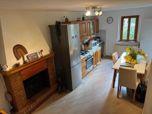 a kitchen with a dining table and a refrigerator at Vicolo dell'Orto in Montaione