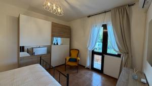 a bedroom with a bed and a chair in it at Casa Irene in Marina di Massa