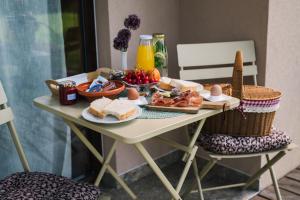 a table with food and eggs and bread on it at Pinja gozdne hiške in Črniče
