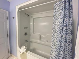 a bath tub with a shower curtain in a bathroom at The Lakes at Ben Eoin Golf Club & Resort in Big Pond +13 photos