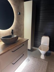 a bathroom with a sink and a toilet at Himos Tomba, Areenan alue in Jämsä +8 photos