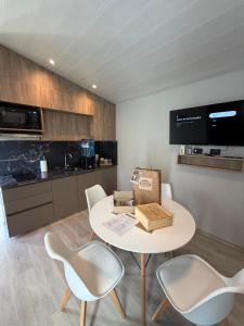 a kitchen with a table and chairs with a box on it at Casa María - Sanagasta in Villa Bustos