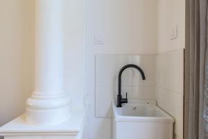 a bathroom with a sink and a faucet at Suite Number 14 in Liévin +18 photos