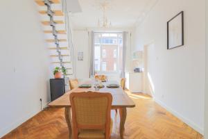 a dining room with a table and some chairs at Suite Number 14 in Liévin