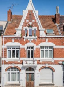 a red brick house with a white at Suite Number 14 in Liévin