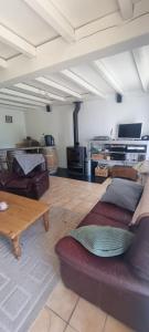 a living room with a couch and a table at Chambres d hôtes Avalanche du rock in Buzy