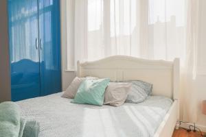 a bedroom with a white bed with pillows on it at Suite Number 14 in Liévin