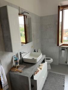 a bathroom with a sink and a toilet at Sonia House Discover Tuscany in Torniella +16 photos