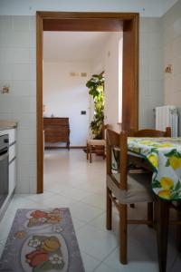 a kitchen with a table and a dining room at Sonia House Discover Tuscany in Torniella
