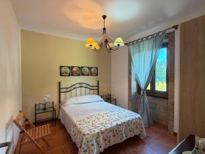a bedroom with a bed and a window at Casa, al lado de las playas in Cee