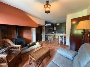 a living room with a couch and a fireplace at Casa, al lado de las playas in Cee