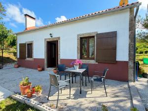 a table and chairs in front of a house at Casa, al lado de las playas in Cee