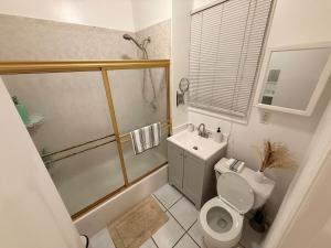 a bathroom with a toilet and a shower and a sink at Spacious 2BR Getaway Easy Access to NYC & Newark in Kearny