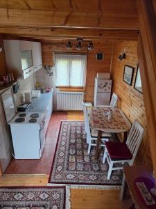 a kitchen and dining room with a table and a stove at Guest house Anka in Žabljak