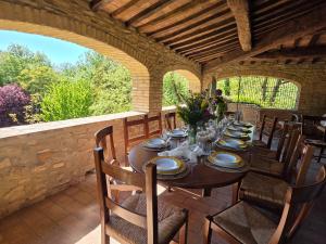 a wooden table with chairs and plates on it at Casale Montone , villa with private pool in Montone
