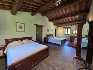 a bedroom with two beds in a room at Casale Montone , villa with private pool in Montone +36 photos