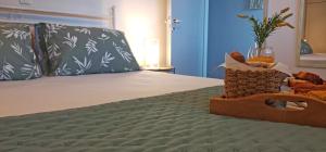 a bed with two pillows and a glass of wine at Lemon Tree Apartment with Garden in Chios
