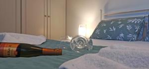 a bottle of wine on top of a bed at Lemon Tree Apartment with Garden in Chios
