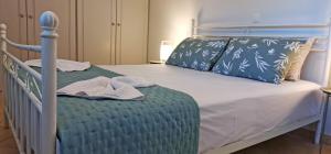 a bedroom with a bed with a blue comforter at Lemon Tree Apartment with Garden in Chios