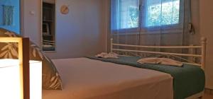 a bedroom with a bed with two towels on it at Lemon Tree Apartment with Garden in Chios +46 photos