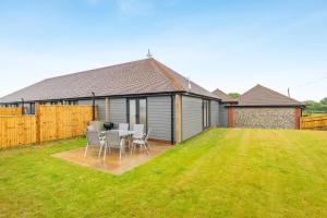 a house with a table and chairs in a yard at 4 Bed in Otterden oc-d36009 in Otterden