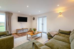 a living room with two couches and a tv at 4 Bed in Otterden oc-d36009 in Otterden