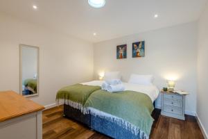 a small bedroom with a bed and a mirror at 4 Bed in Otterden oc-d36009 in Otterden