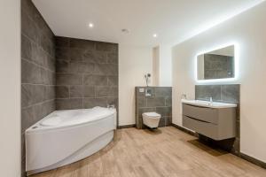 a bathroom with a tub and a toilet and a sink at 4 Bed in Otterden oc-d36009 in Otterden +21 photos