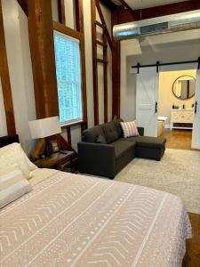a bedroom with a bed and a couch and a living room at Riverbend Suite - Potter’s Mill in Bellevue