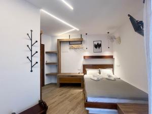 a small bedroom with a bed and a mirror at Haus Niko Apartments and Suites in Nea Potidaea