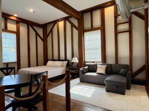 a living room with a couch and a bed and a table at Riverbend Suite - Potter’s Mill in Bellevue