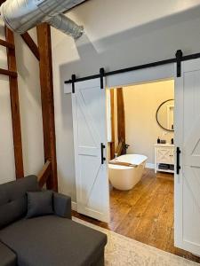 a bathroom with a sliding door leading to a tub at Riverbend Suite - Potter’s Mill in Bellevue