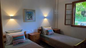 a bedroom with two beds and a window at Holiday Home Neochori Pelion in Neochori