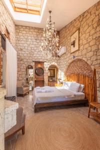 a large bedroom with a large bed and a chandelier at NURİYE ALACATI in Alaçatı +181 photos