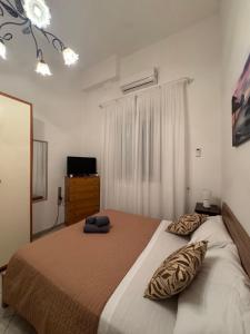 a bedroom with a bed with two pillows on it at La Dimora di Zia Rosa in Crotone +2 photos