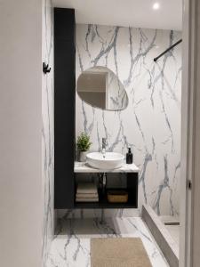 a bathroom with a sink and a mirror at ZWIN Apartment 4 in Skole