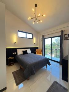 a bedroom with a bed and a large window at HOTEL BOUTIQUE ÁRBOL De LA VIDA in Taxco de Alarcón +67 photos