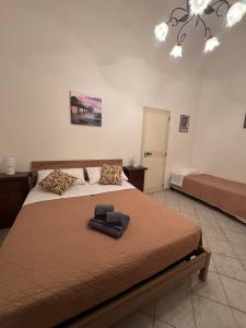 a bedroom with a large bed with a brown blanket at La Dimora di Zia Rosa in Crotone
