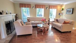 a living room with two couches and a fireplace at Charlotte Garden Bed and Breakfast in Niagara-on-the-Lake