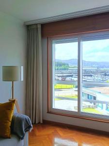 a room with a large window in a hotel room at Viveiro Centro con Vistas in Viveiro +21 photos