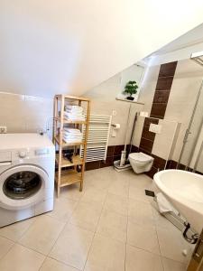 a bathroom with a washing machine and a sink at Lucky center Ljubljana in Ljubljana +40 photos